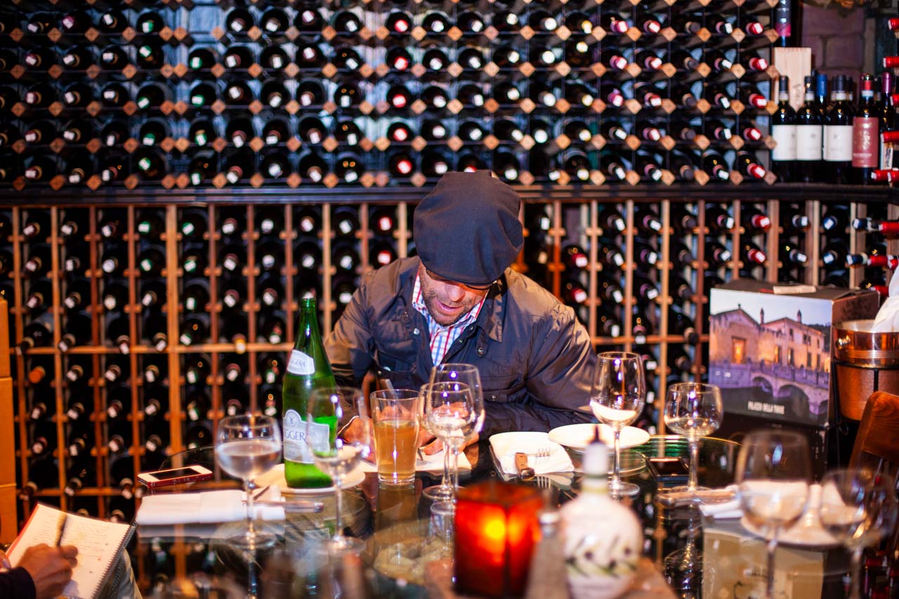 Man with many wine bottles