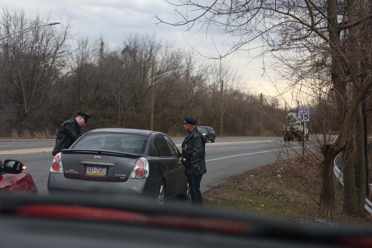 Police officers stopping a car
