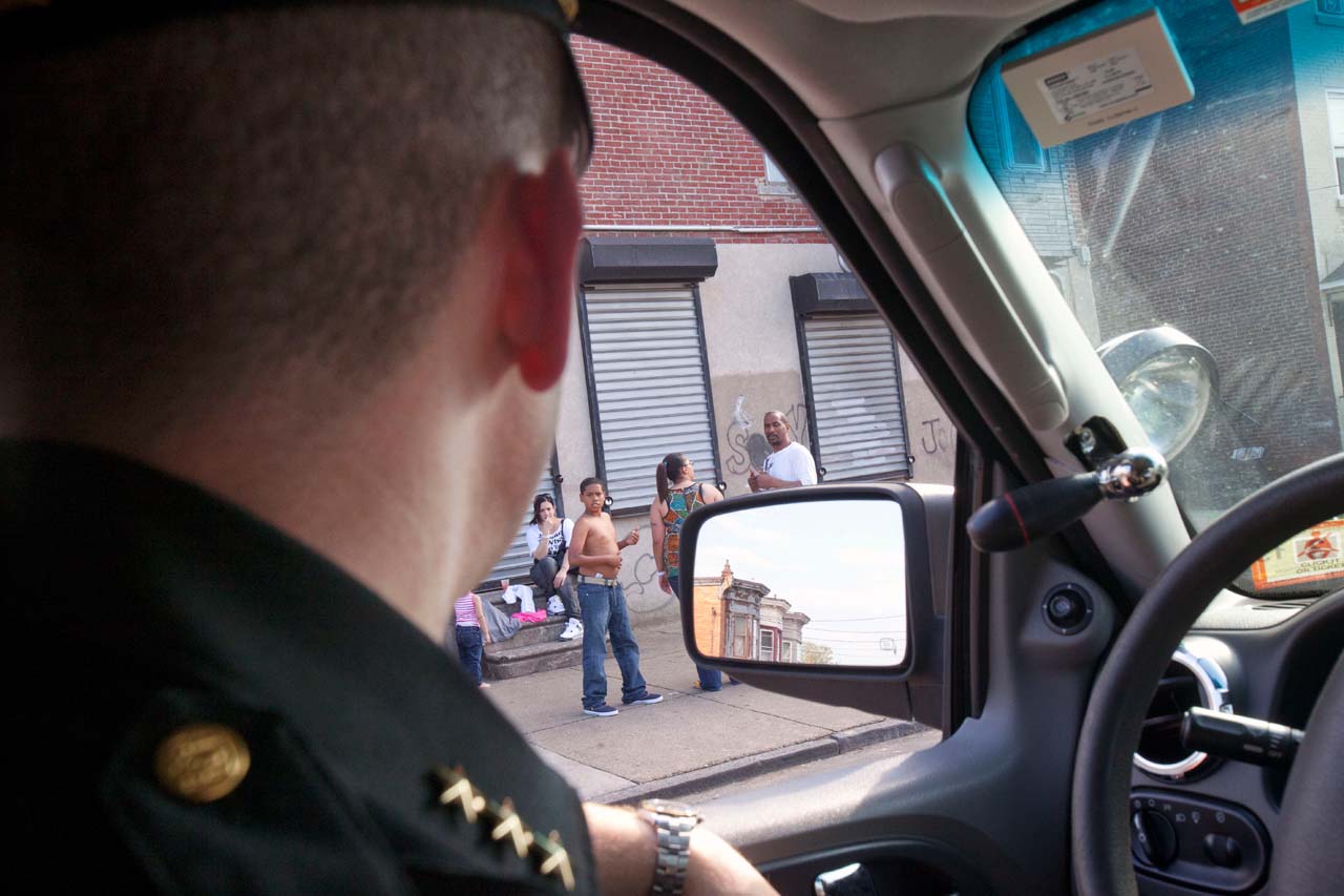 Police officer watching a young man