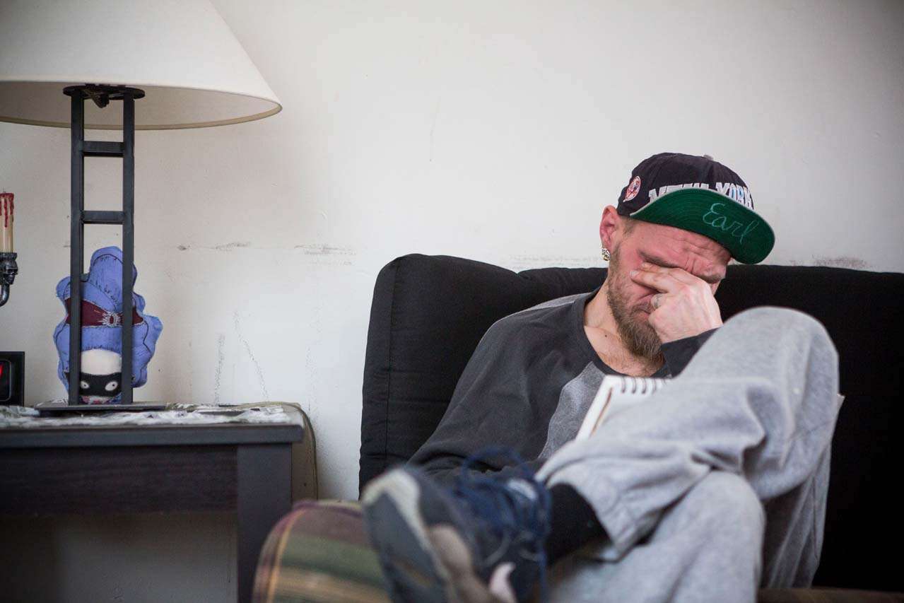Man crying on sofa